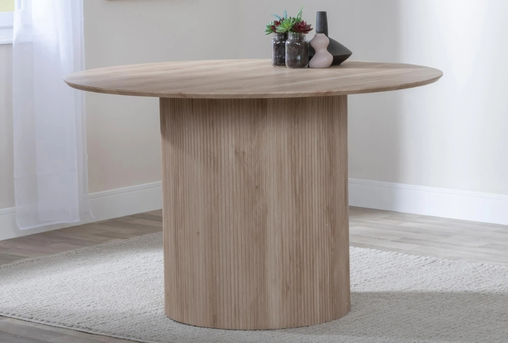 Bern Fluted 4 Seater Oak Effect Round Dining Table with Drum Base in a small dining room
